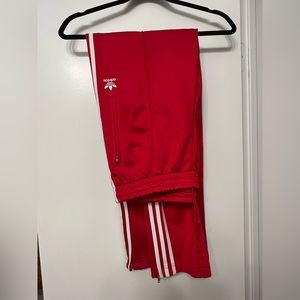 Red Adidas track pants size large.